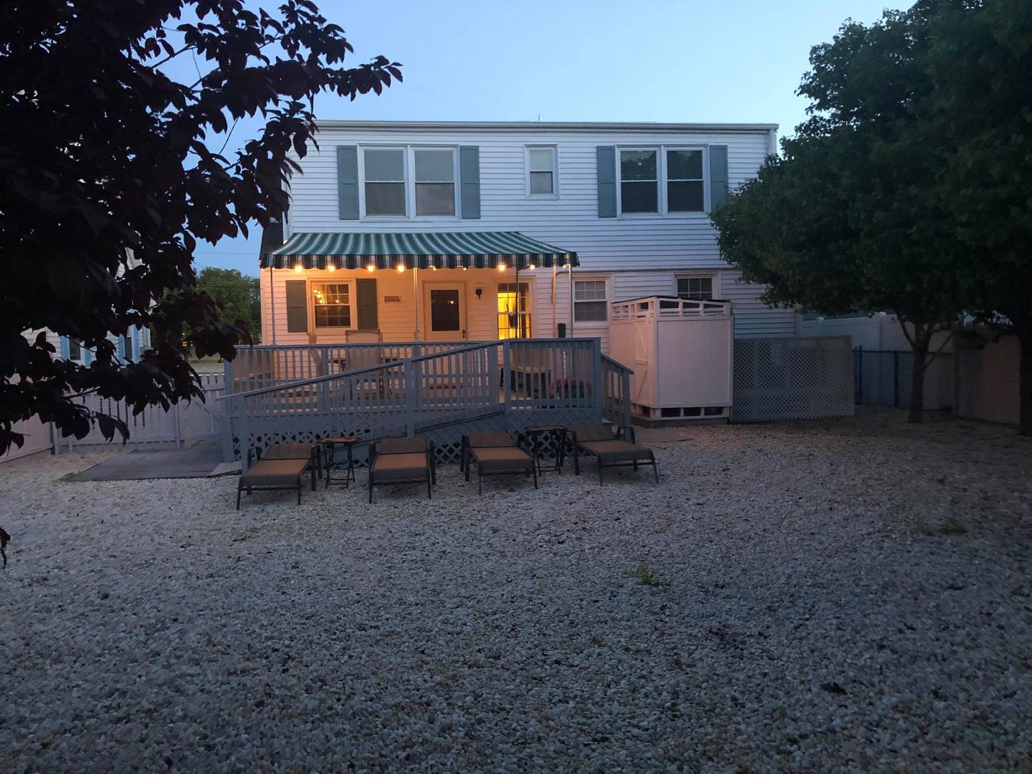 23 New York Ave at dusk, deck and fenced yard